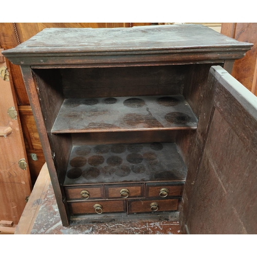 1006 - A small oak straight front wall handing spice cupboard with brass hinges and escutcheon, with 5 draw... 