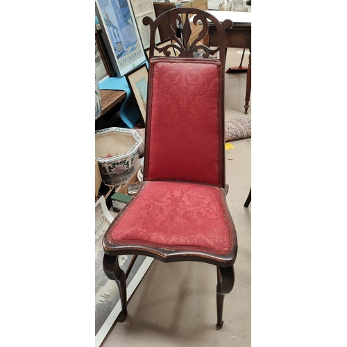 1010 - An Art Nouveau style high back chair with carved and pierced top section, red upholstery