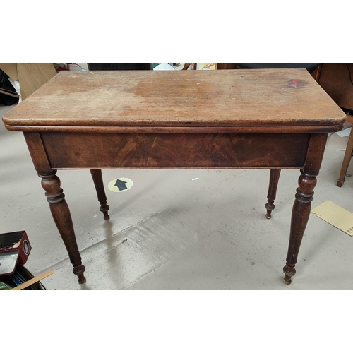 1018A - A mahogany fold over tea table with turned legs