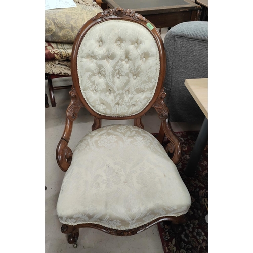 906 - A Victorian carved walnut armchair with oval back and seat upholstered in deeply buttoned cream broc... 