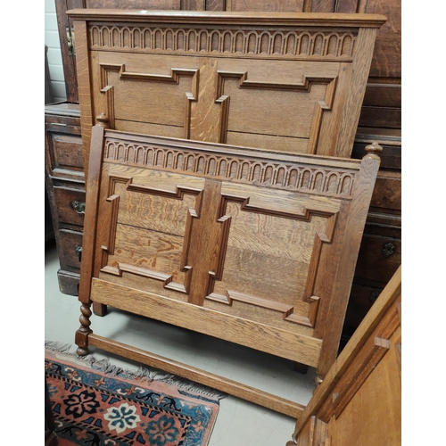 928a - A 1930's pair of period style 3' bed ends in golden oak with geometric moulded decoration