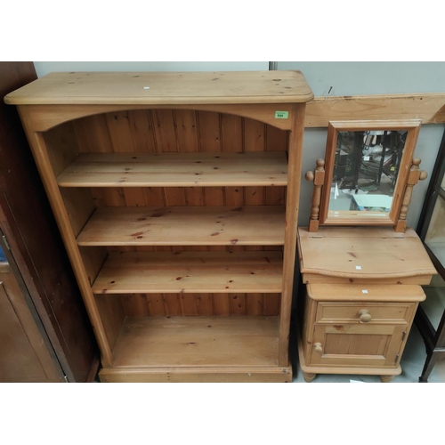 944 - A pine 4 height bookcase; a pine bedside cabinet; a dressing table mirror