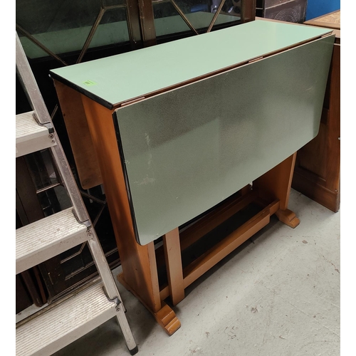 988 - A mid 20th century Formica top drop leaf table with lightwood base and circular stool