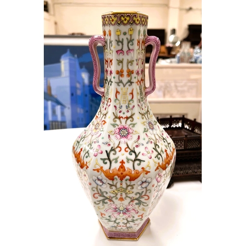 464 - A Chinese porcelain vase of hexagonal baluster form with loop handles, polychrome stylised floral de... 