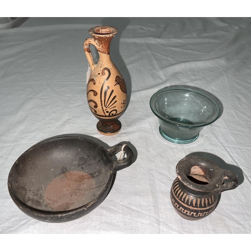 597 - A small earthenware bowl with single handle, bearing dealer's label:  Greek Colony S. Italy 4th... 