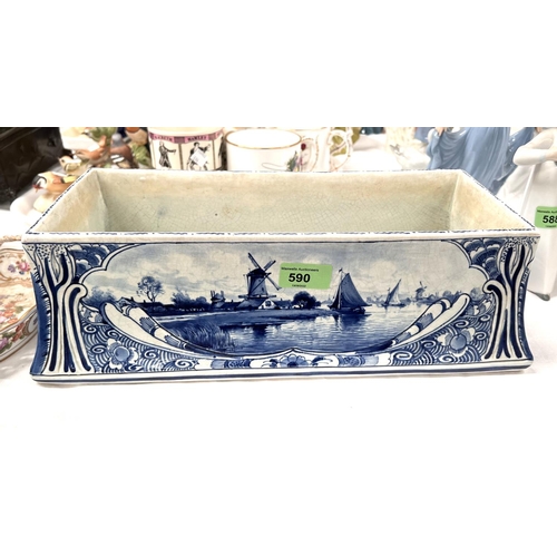 590 - A Delftware rectangular flower trough decorated with Dutch scenes, length 40cm (glaze crazing)