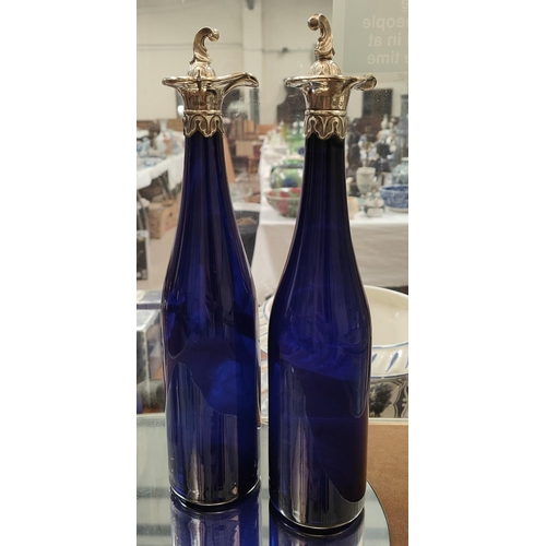 870 - A pair of Bristol blue wine bottles with silver poring spout mounts, Sheffield 1843, and matching st... 