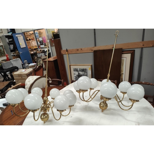 97 - A pair of eight branch central chandelier brass light fitting with opaque light globes, a brass sphe... 