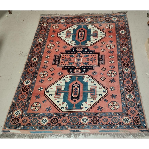 984 - A large rust ground Turkman woollen carpet 247 x 210 cm