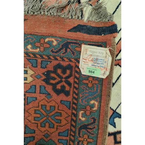 984 - A large rust ground Turkman woollen carpet 247 x 210 cm