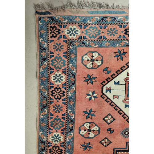 984 - A large rust ground Turkman woollen carpet 247 x 210 cm