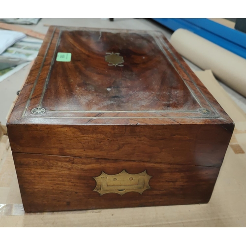 106 - A Victorian lap desk in crossbanded walnut and rosewood, with extensive brass inlay and fitted inter... 