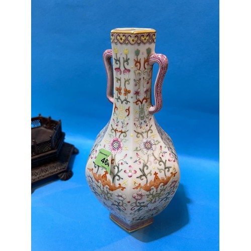 464 - A Chinese porcelain vase of hexagonal baluster form with loop handles, polychrome stylised floral de... 