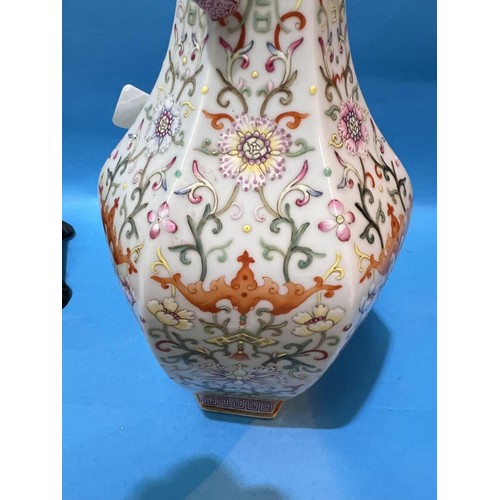 464 - A Chinese porcelain vase of hexagonal baluster form with loop handles, polychrome stylised floral de... 