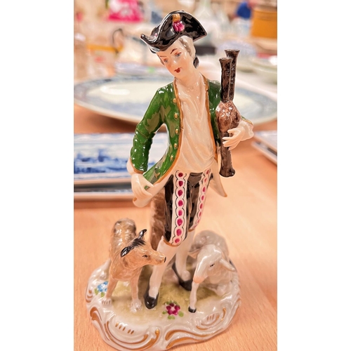 579 - A late Meissen figure:  man in 18th century dress with bagpipes and sheep, crossed swords mark; a se... 