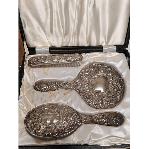 634A - A cased three piece silver brush and mirror set