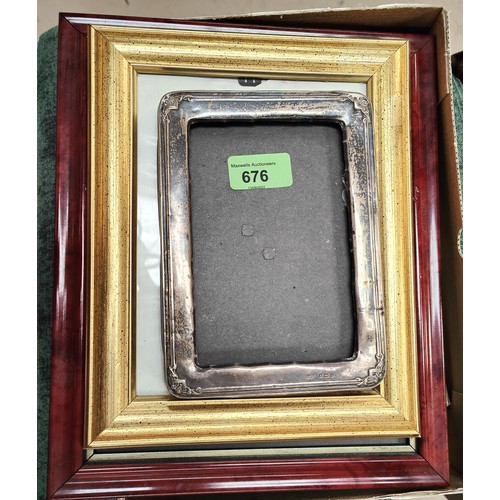 676 - A hallmarked silver rectangular photo frame, Birmingham 1913; other photo frames