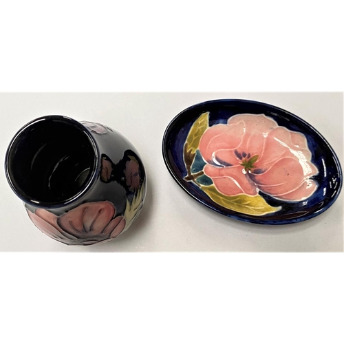 505 - A Moorcroft squat vase with dark blue ground poppy decoration, ht. 9.5cm; a small Moorcroft dish, 11... 