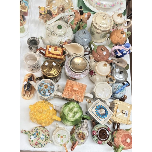 549 - A large collection of novelty and decorative teapots, 34 approx