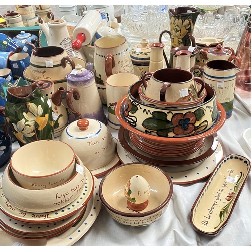 577 - A large selection of motto pottery, mainly larger cream and brown pieces