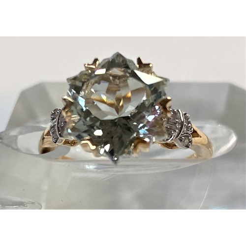 666 - A lady's 9 carat gold dress ring set Wobito snowflake cut prasiolite stone, 4.12 carat, flanked by 4... 