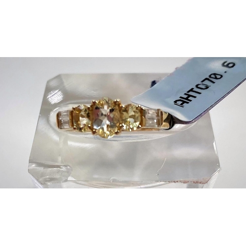 666 - A lady's 9 carat gold dress ring set Wobito snowflake cut prasiolite stone, 4.12 carat, flanked by 4... 