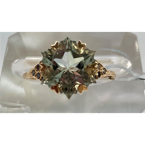 667 - A lady's 9 carat gold dress ring set central large Wobito snowflake prasiolite, 4.11 carats, ea... 