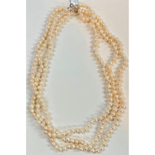 680 - A triple necklace of naturally coloured kaori pearls, 6.5 x 5mm; a similar pearl pendant necklace an... 