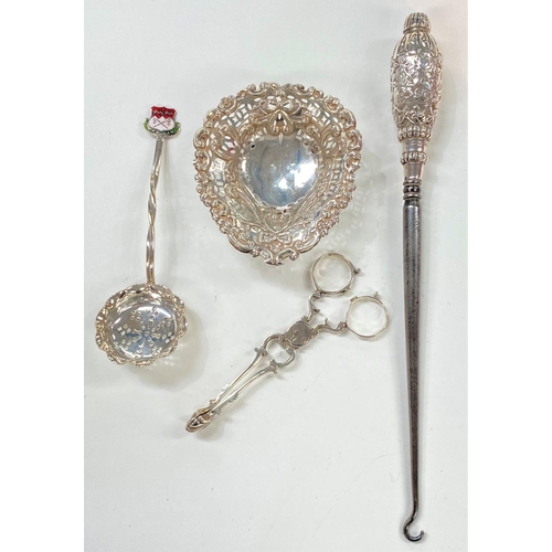 718 - A hallmarked silver pierced and embossed bonbon dish; a silver handled button hook; a pair of Georgi... 