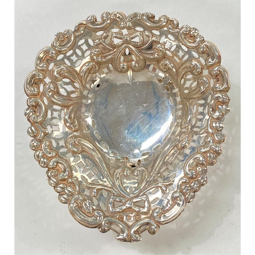 718 - A hallmarked silver pierced and embossed bonbon dish; a silver handled button hook; a pair of Georgi... 