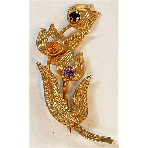 740 - A 9 carat hallmarked gold brooch in the form of flowers and leaves, set coloured stones, 8.8gm