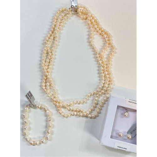 680 - A triple necklace of naturally coloured kaori pearls, 6.5 x 5mm; a similar pearl pendant necklace an... 