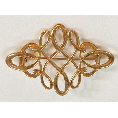 734 - A 9 carat hallmarked gold diamond shaped brooch formed from scrolls and loops, 6.4gm