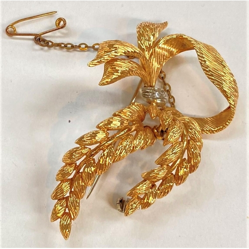 739 - A yellow metal brooch in the form of a bow ad fern leaves, set 2 small diamonds, impressed mark uncl... 