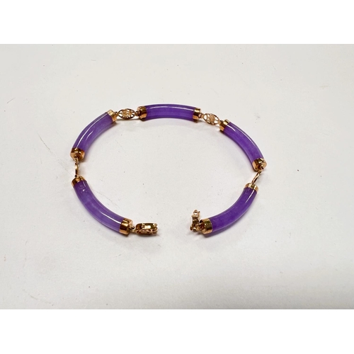 714 - A Chinese Lilac Jade Bracelet with 14 carat gold mounts.