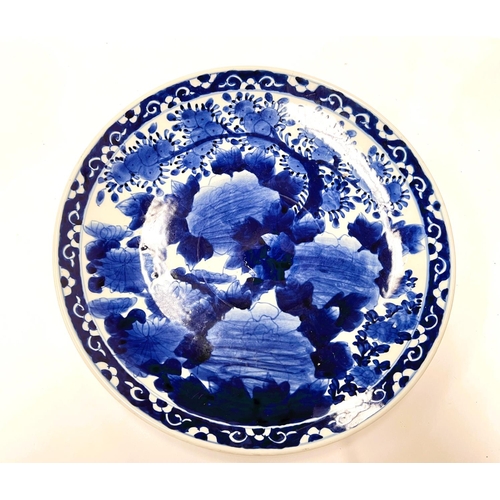 443 - A large Japanese blue and white charger with floral decoration to the interior and rim, diameter 37c... 