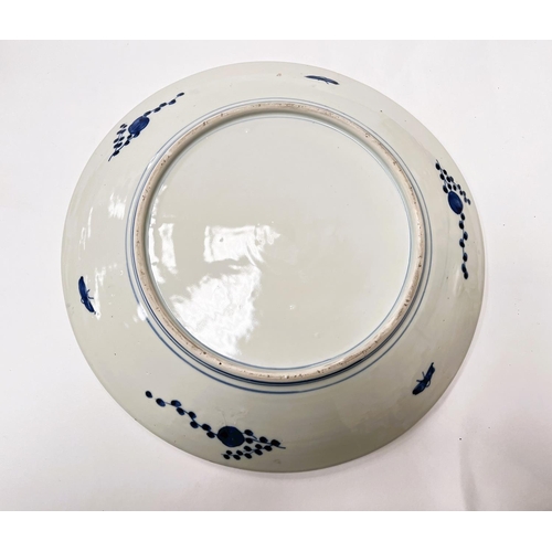 443 - A large Japanese blue and white charger with floral decoration to the interior and rim, diameter 37c... 