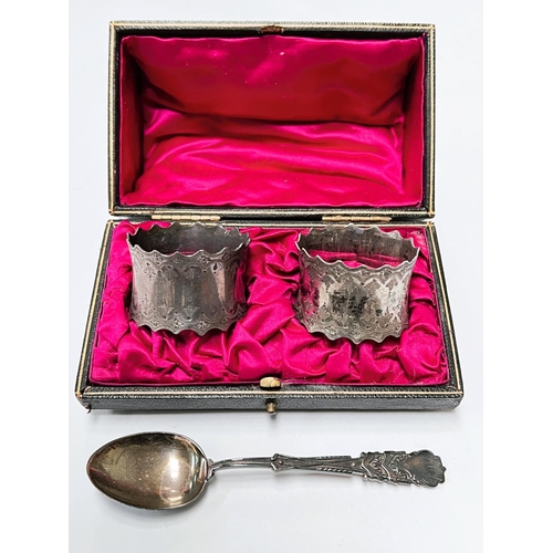 639 - A cased pair of hallmarked silver napkin rings with incised decoration with waving borders, Sheffiel... 