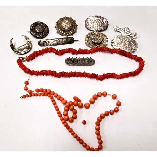 650 - A selection of silver/white metal brooches, coral necklaces, etc.