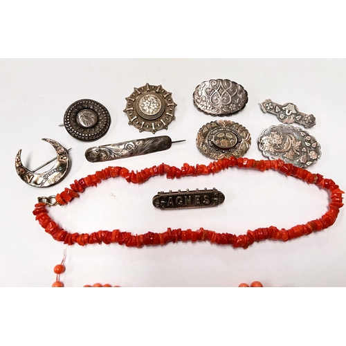 650 - A selection of silver/white metal brooches, coral necklaces, etc.