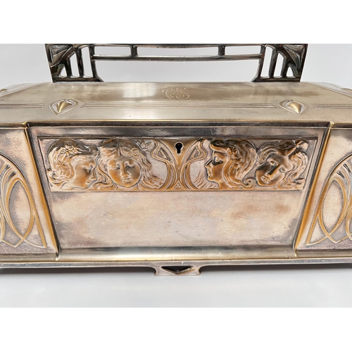 703 - An Art Deco silver plate WMF 'Four Seasons' jewellery casket with embossed faces, length 43cm