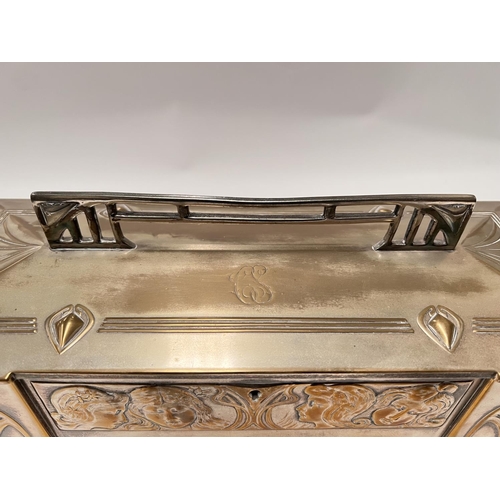 703 - An Art Deco silver plate WMF 'Four Seasons' jewellery casket with embossed faces, length 43cm