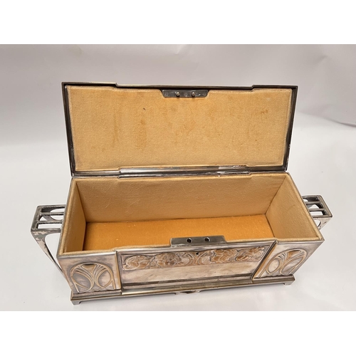 703 - An Art Deco silver plate WMF 'Four Seasons' jewellery casket with embossed faces, length 43cm