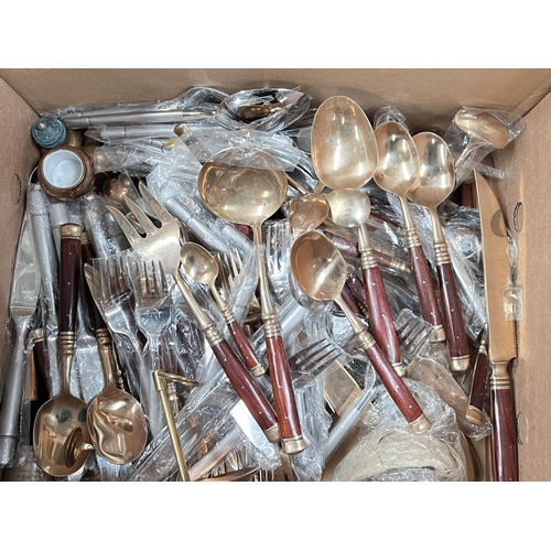 705 - A large selection of brass and other cutlery. 