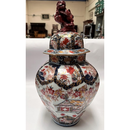 439 - A 19th century Japanese Imari octagonal lidded vase with floral decoration, Dog of Fo to finial (res... 