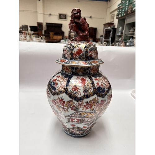 439 - A 19th century Japanese Imari octagonal lidded vase with floral decoration, Dog of Fo to finial (res... 