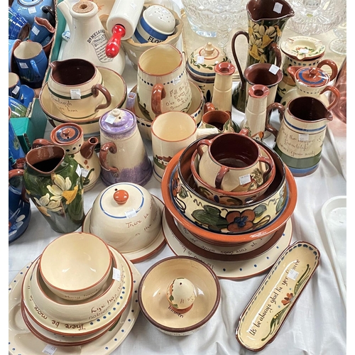 577 - A large selection of motto pottery, mainly larger cream and brown pieces