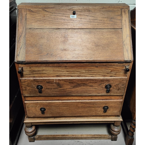 1001 - A 1930's oak bureau with fall front and 3 drawers under