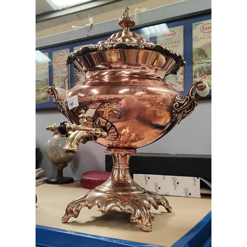 145 - An early 19th century copper samovar with brass top and mik glass handles, 46cm