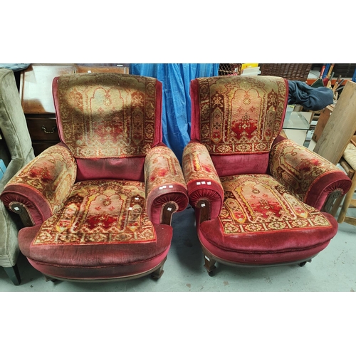 948 - A pair of Victorian oak framed armchairs with Turkey carpet upholstery 